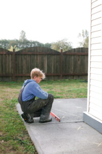 installer measuring sidewalk levels