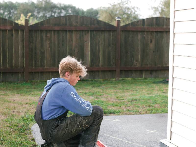 installer measuring sidewalk levels