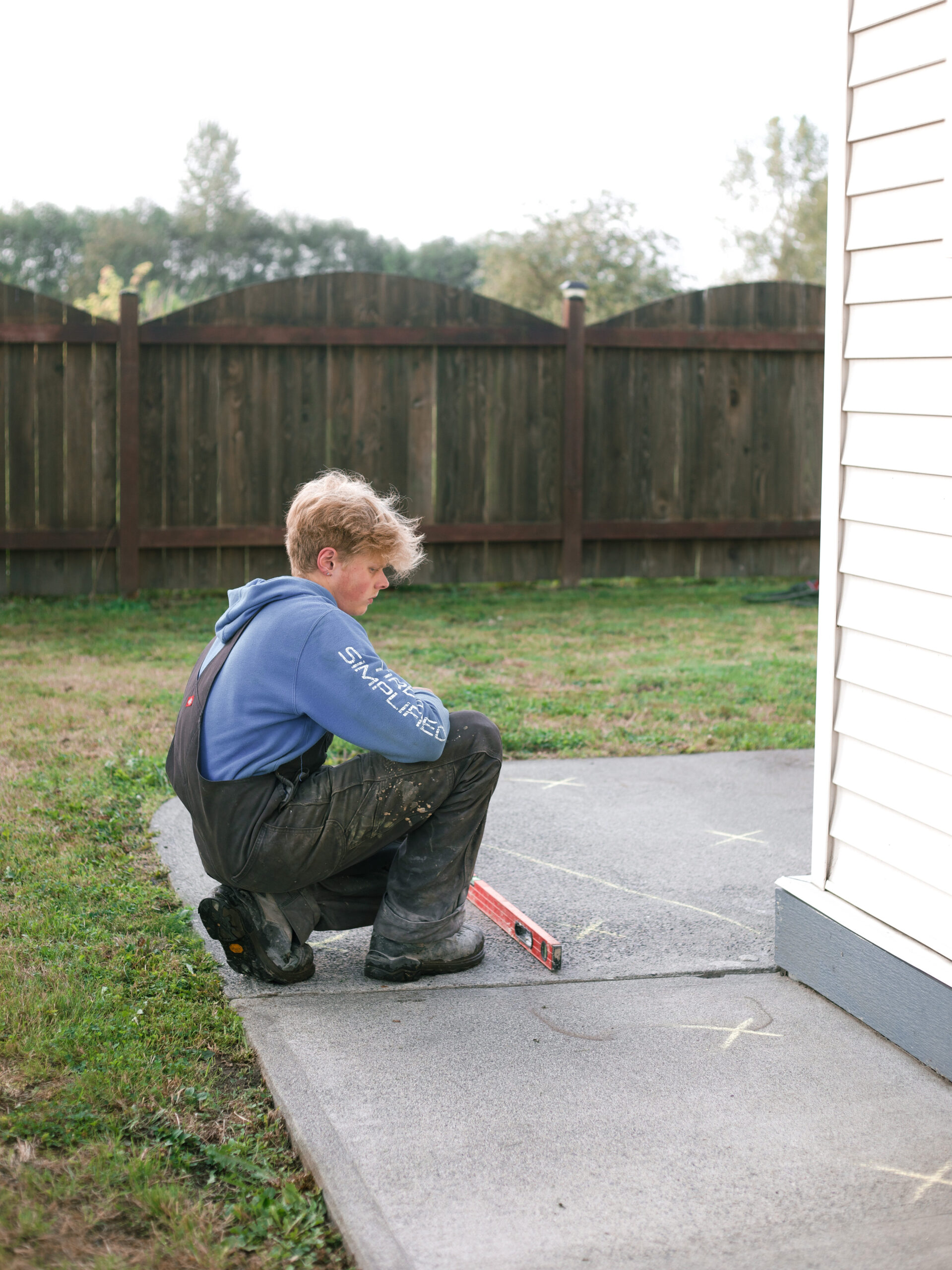 installer measuring sidewalk levels