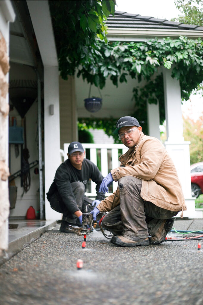 Crew installing polylevel into a driveway