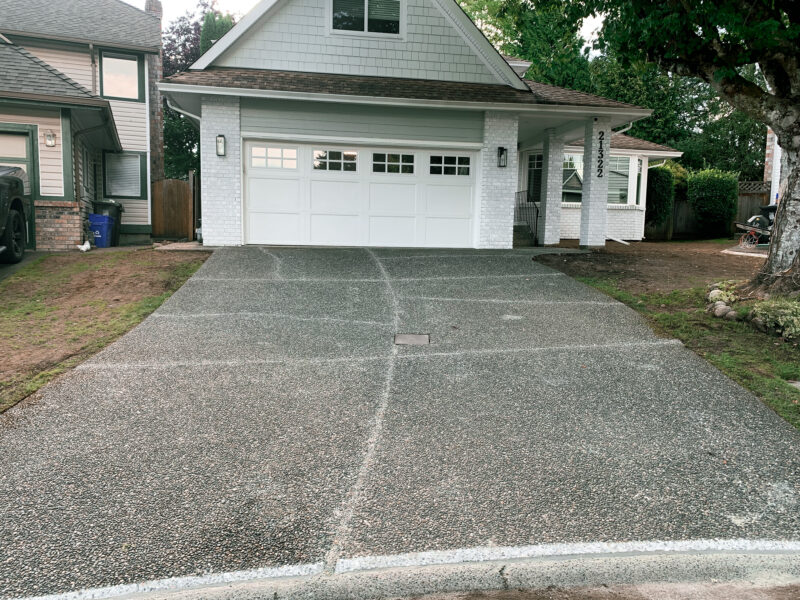 house with repaired concrete driveway